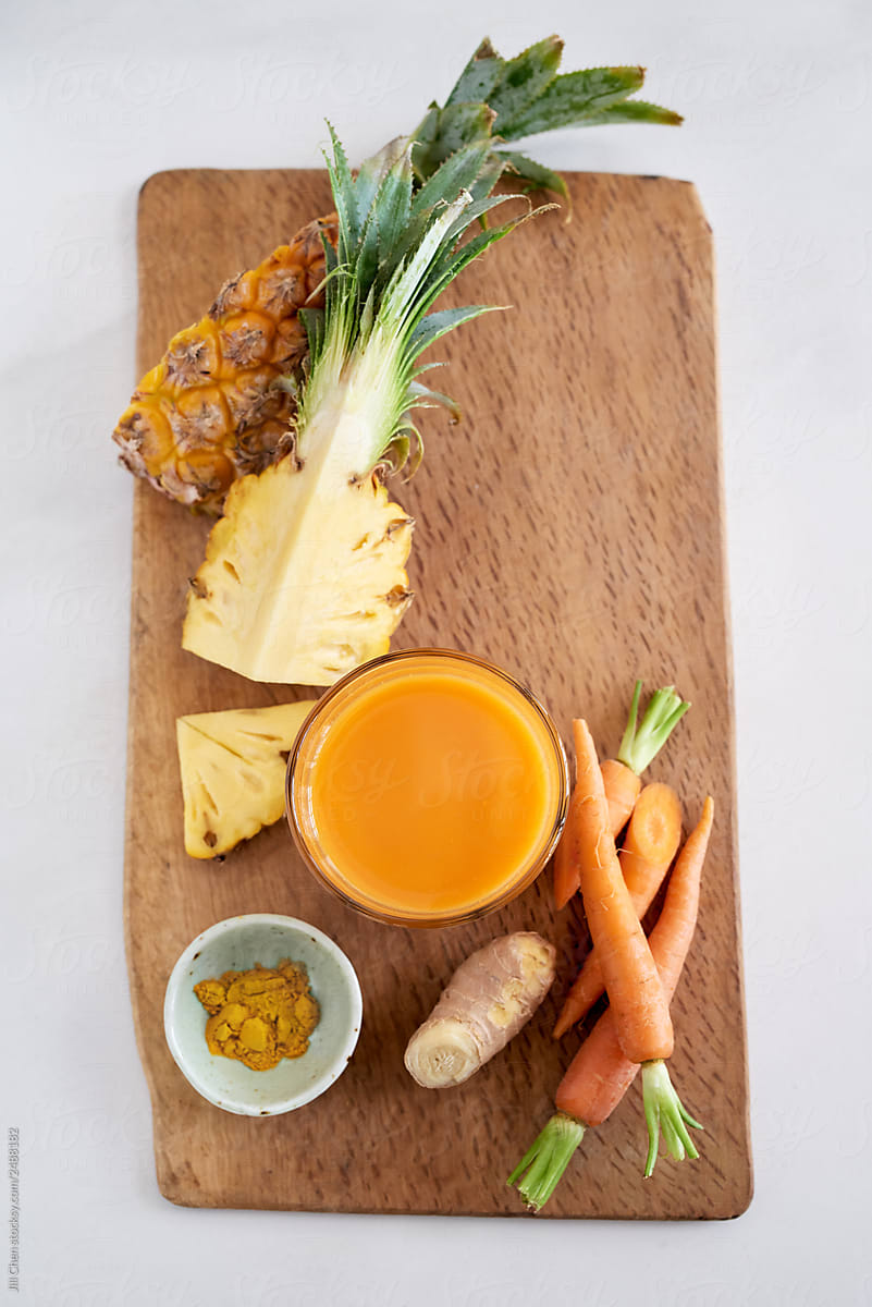 Overhead of cold pressed juice and raw ingredients