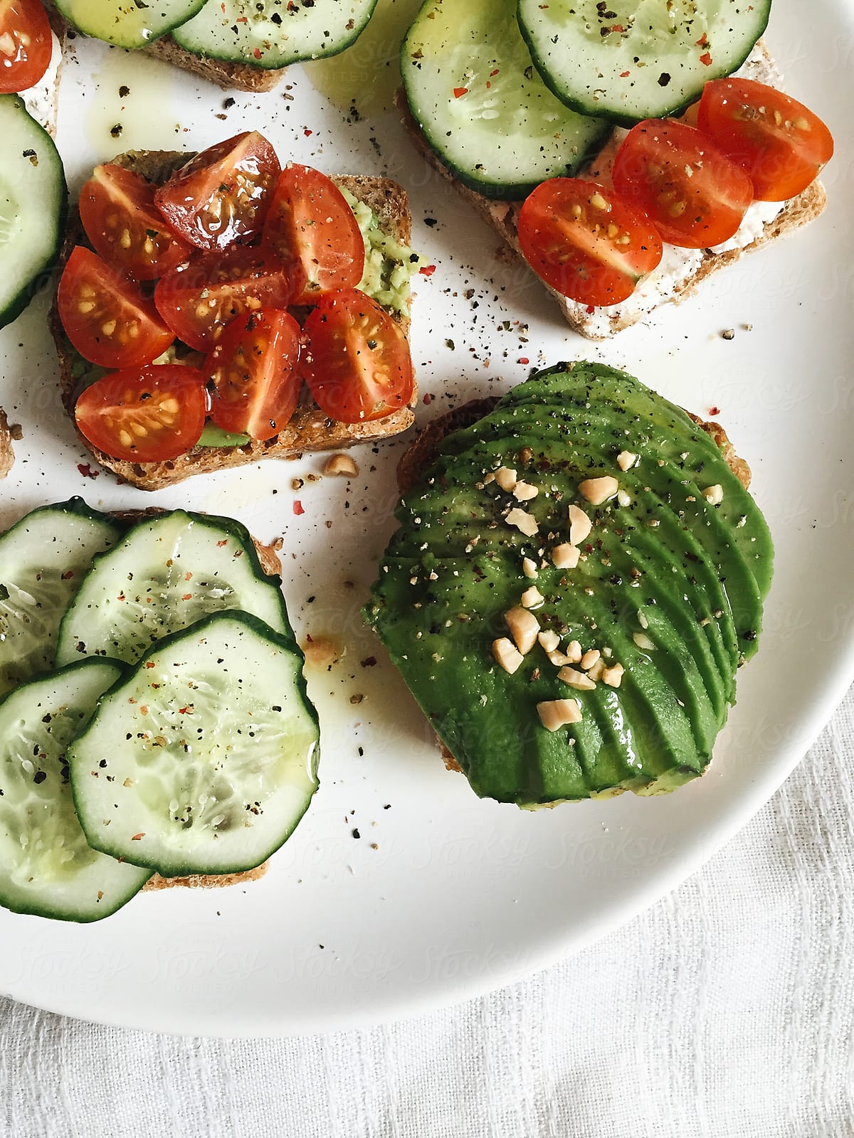 Toasts with avocado, tomatoes and cucumber