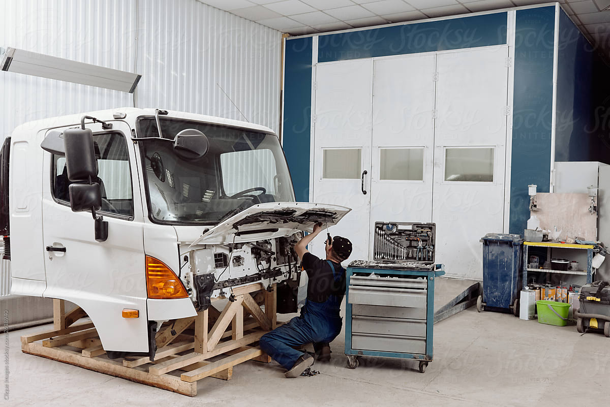 Auto Service Worker Repairing Truck Front End