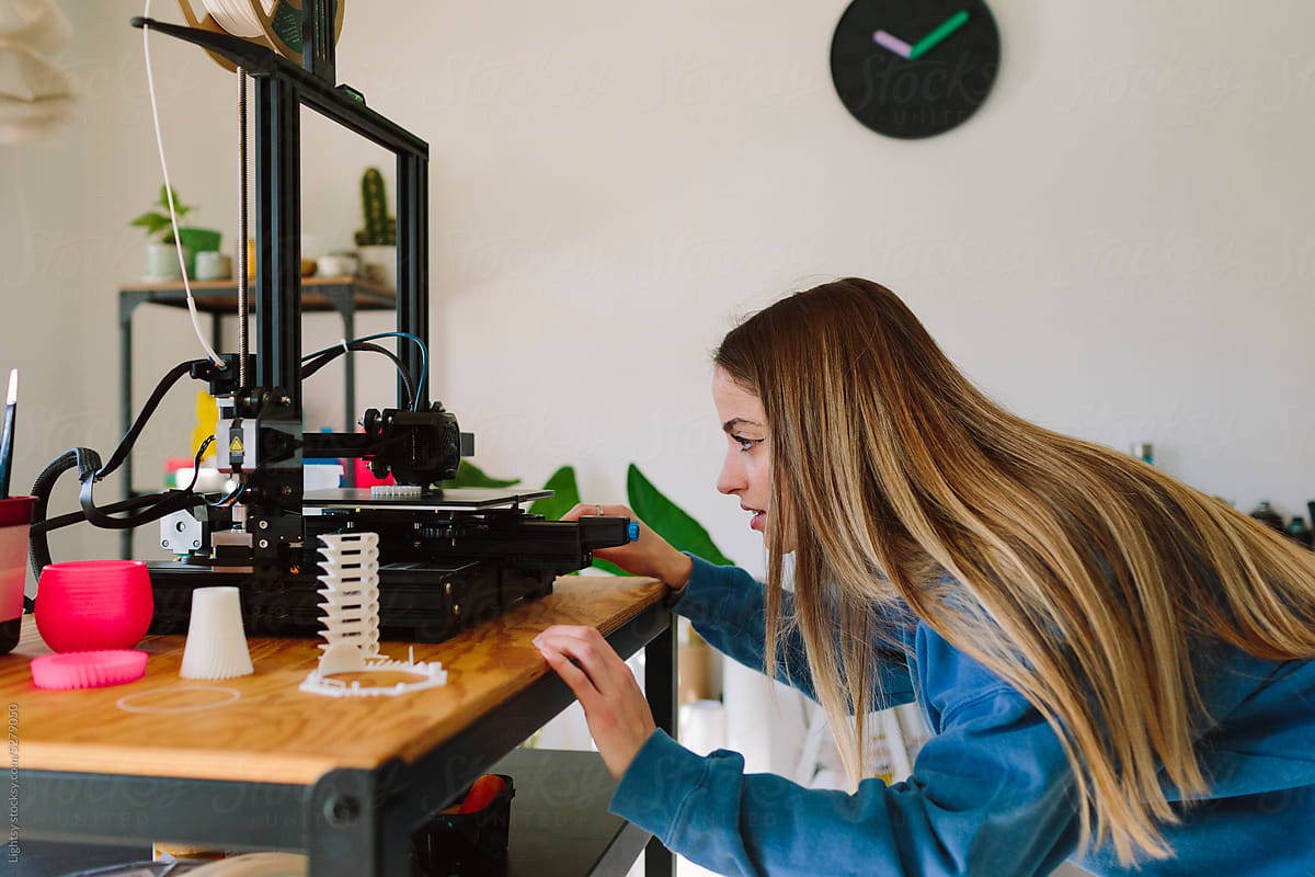 Woman looking at a 3D printer