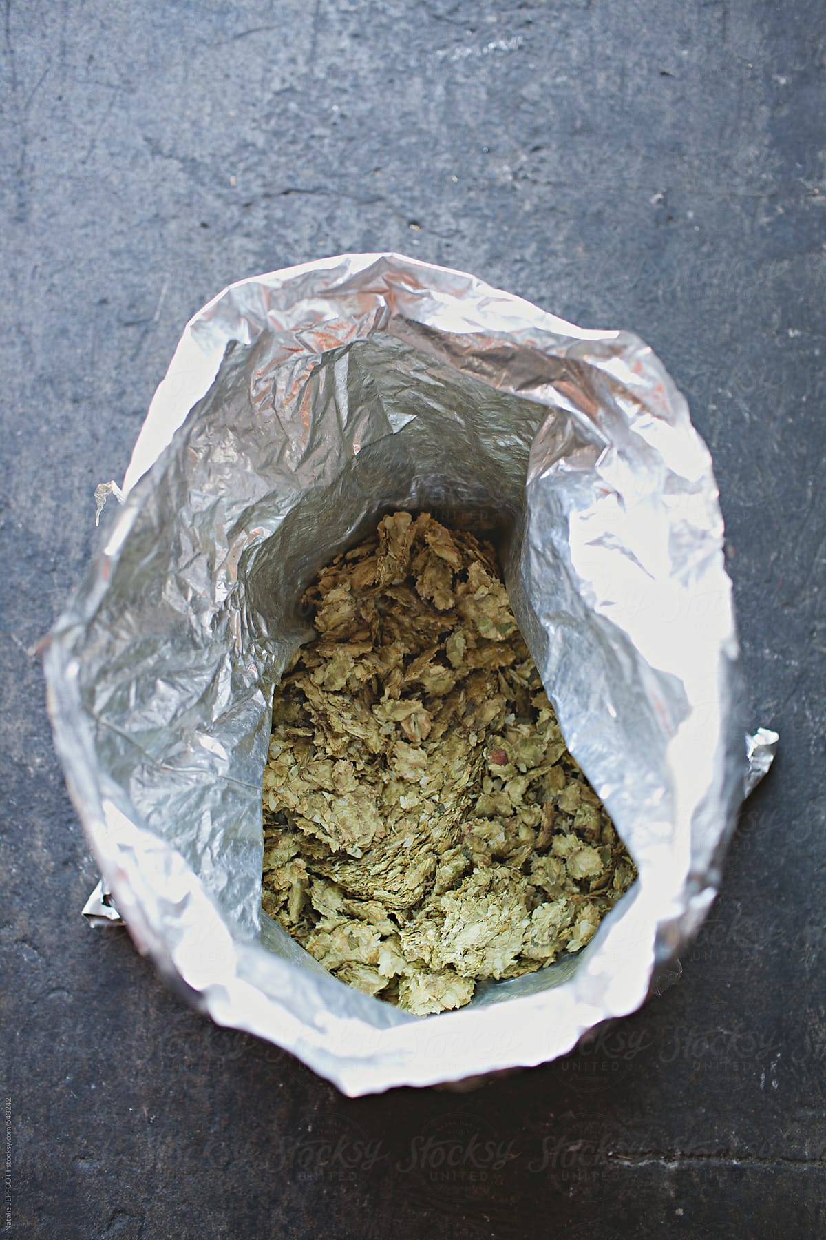 dried hops used in brewing beer in silver bag on concrete floor