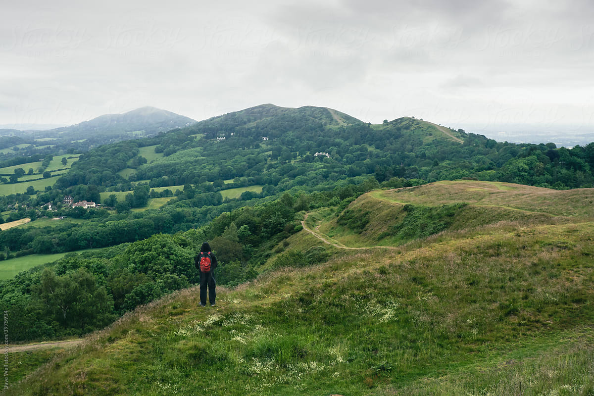 A hiker with rucksack, back to camera on a hill