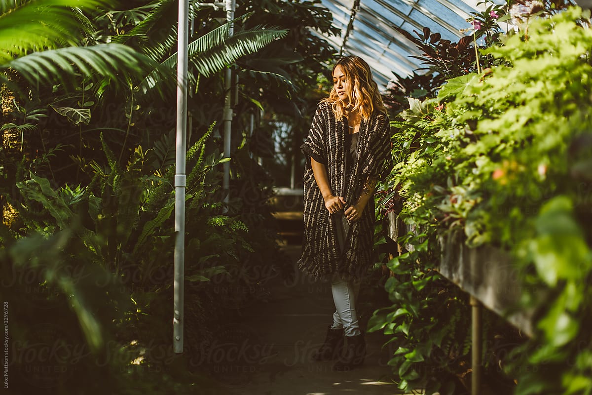 Portrait Of Young Beautiful Asian American Woman In Greenhouse