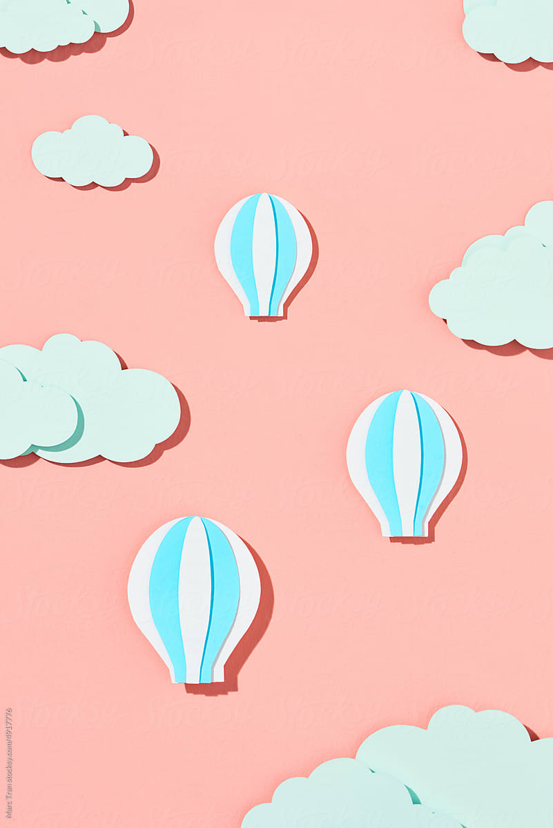 White and blue hot air balloons in clouds paper cut