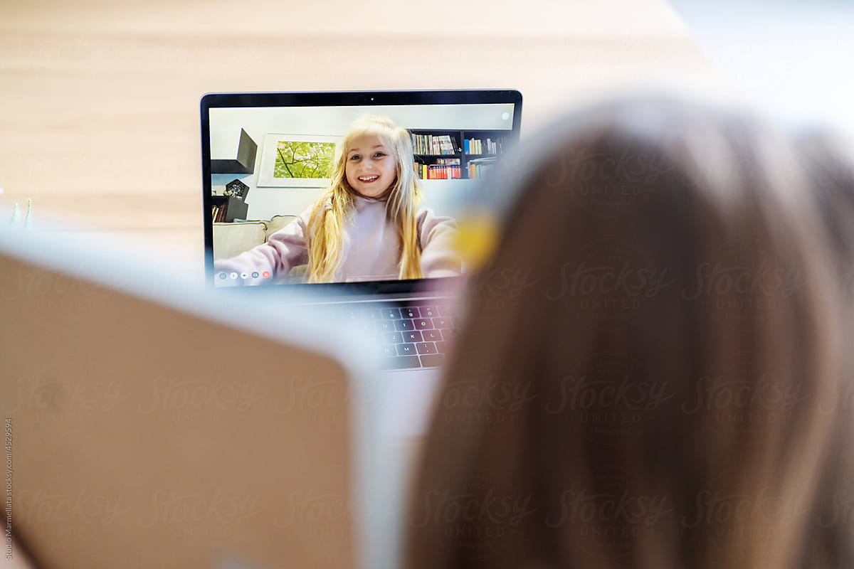 Child talking to teacher during online lesson