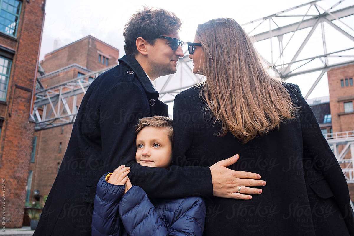 Outdoor portrait of a stylish family of three