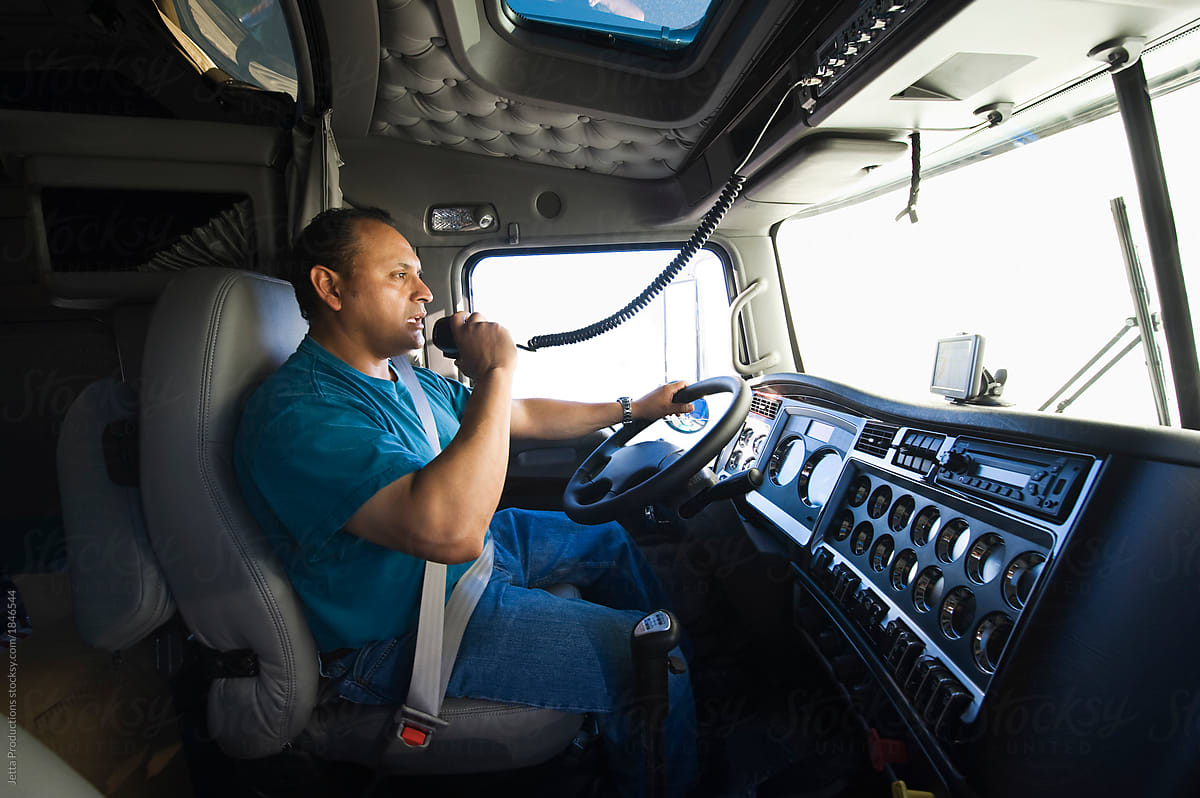 Male truck driver inside of a truck