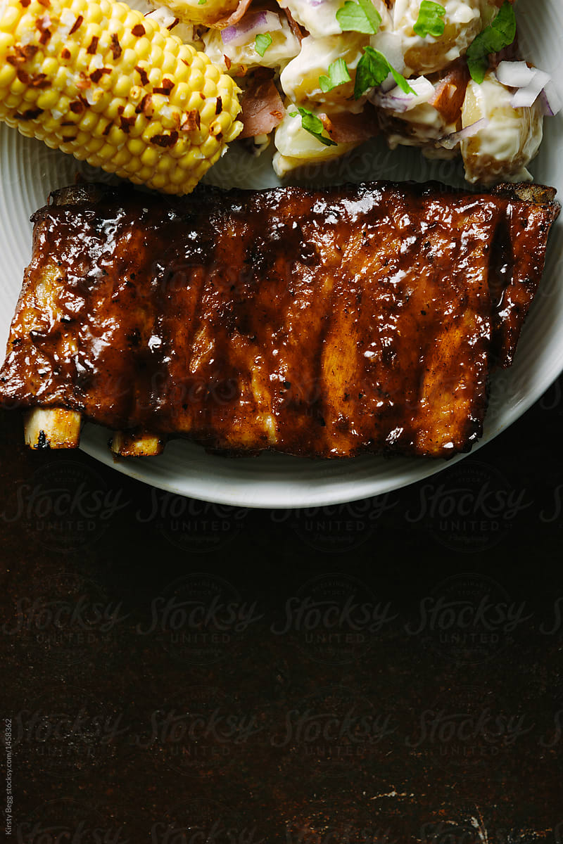 Half rack of bbq ribs on plate with copy space