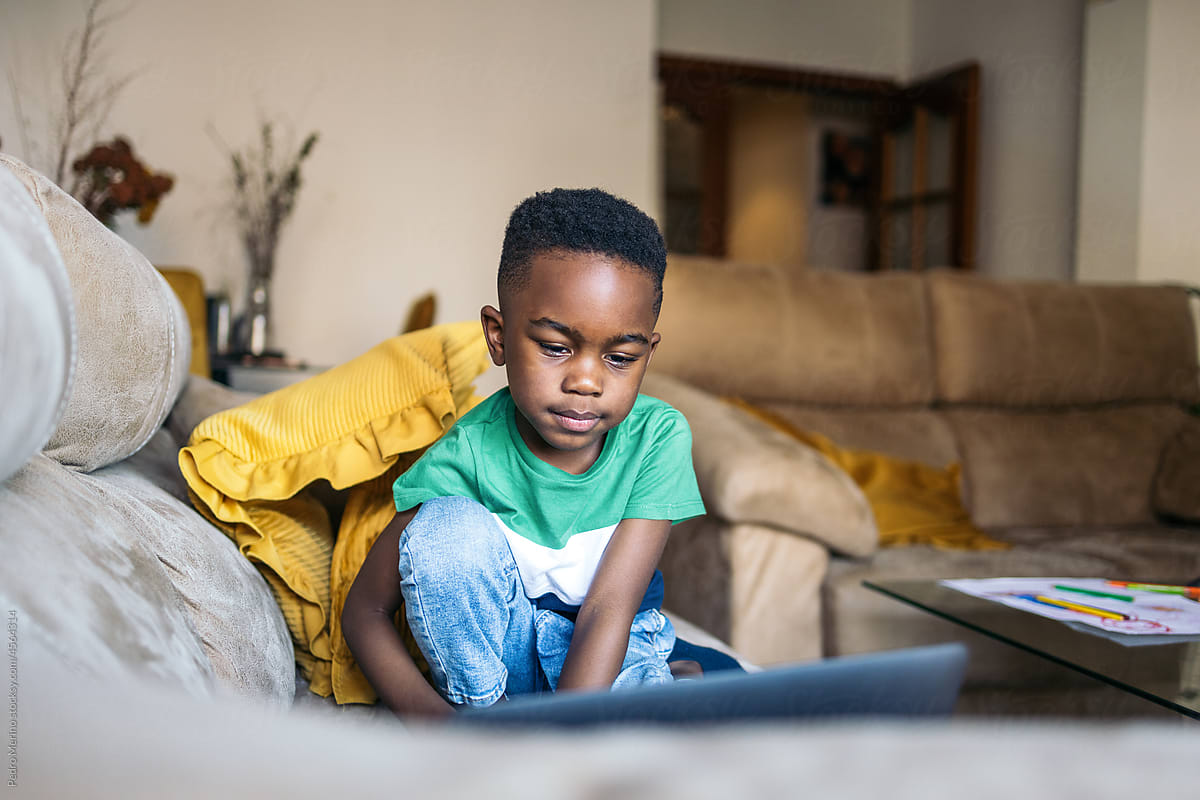 Little boy with laptop at home