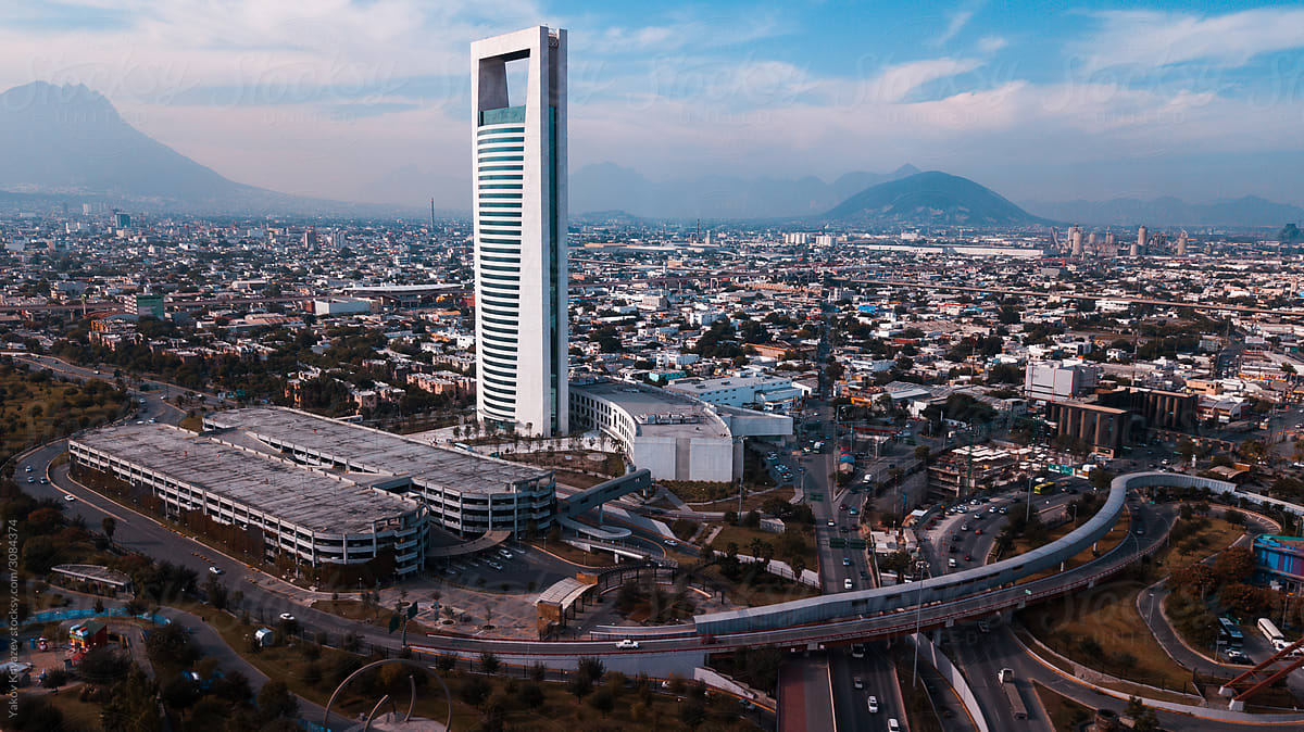 drone shot of a skyscraper against the Monterrey cityscape