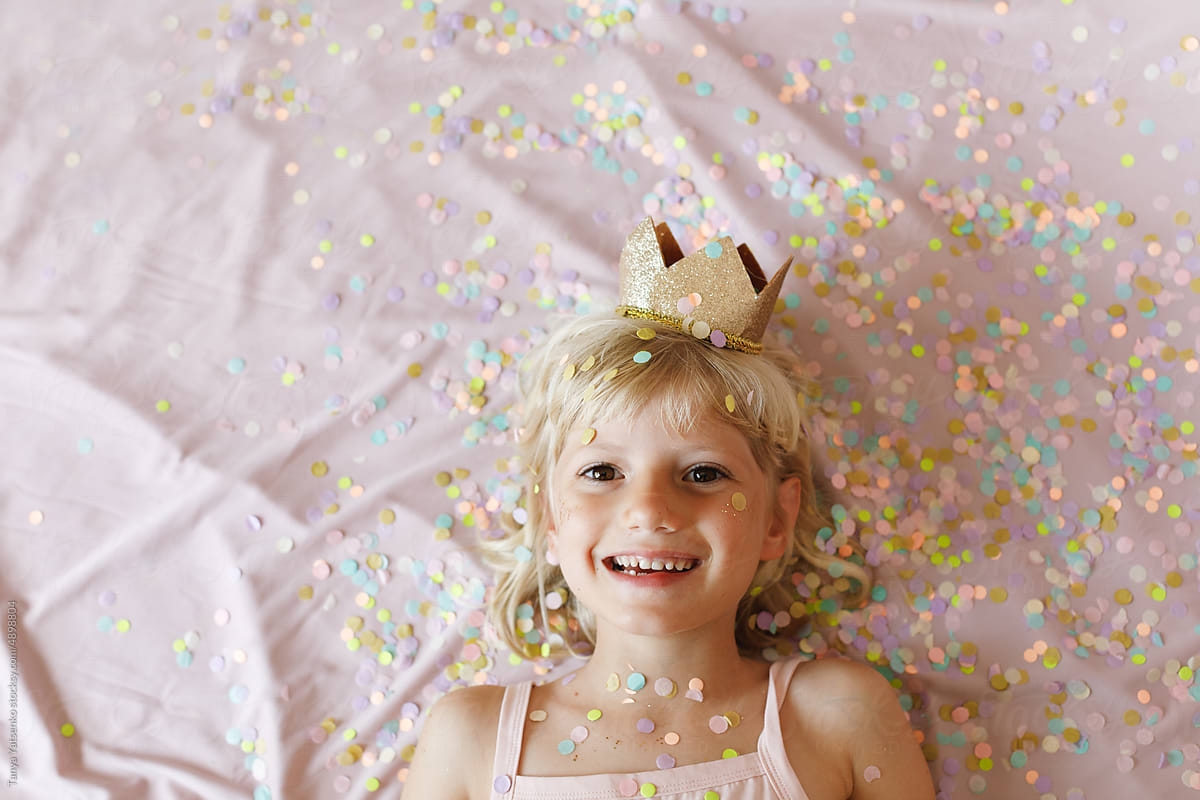 A birthday girl with confetti and a crown