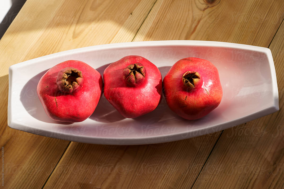 Ripe Pomegranates Fruits On Wooden Table Background.