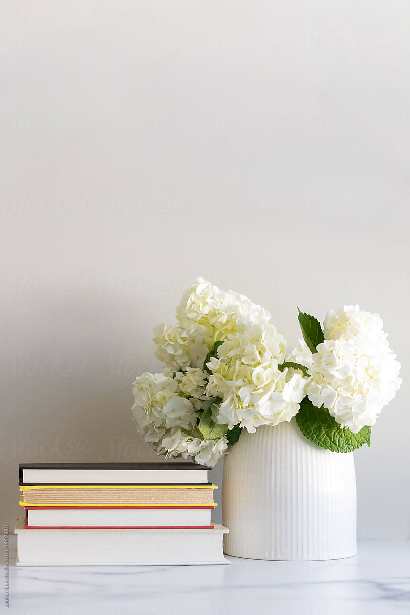 Books on a desk with flowers