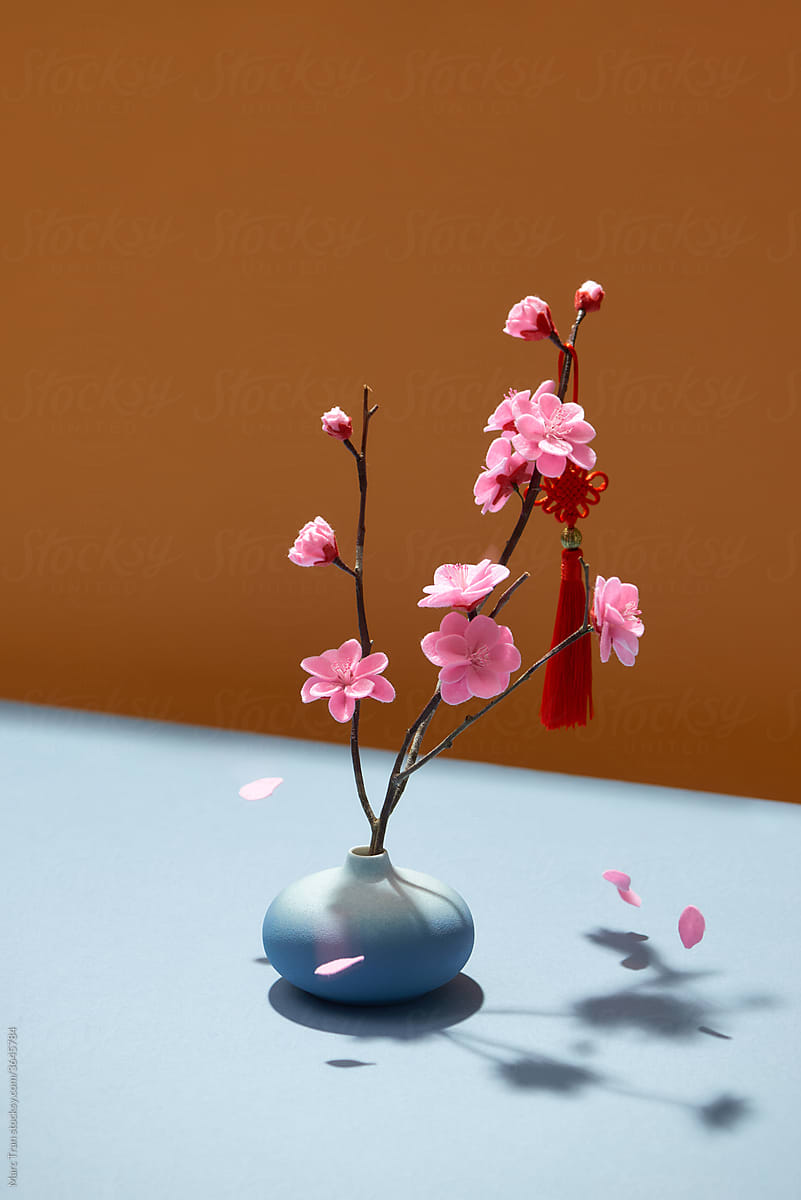 Springflowers blooming in vase with lucky knot