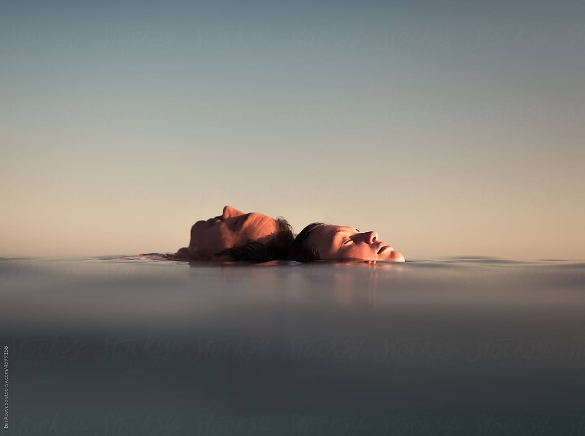 Couple enjoying peaceful moment floating in the sea