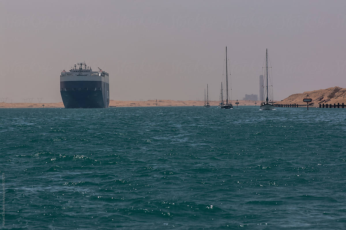sailboats and a cargo ship on Suez Canal, Egypt