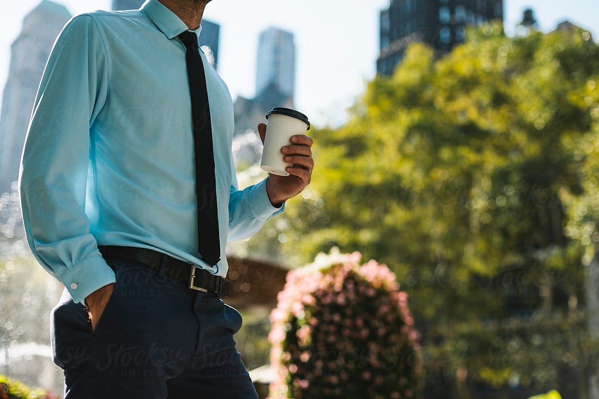 Businessman holding a coffee cup in the city