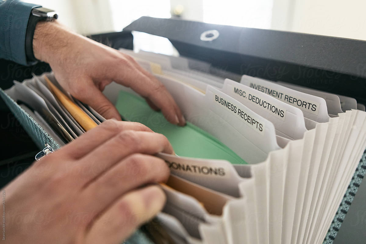 Taxes: Man Looks Through Files Of Business Receipts