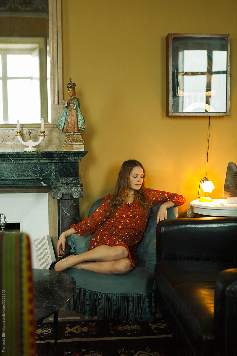 Portrait of Young woman relaxing on armchair