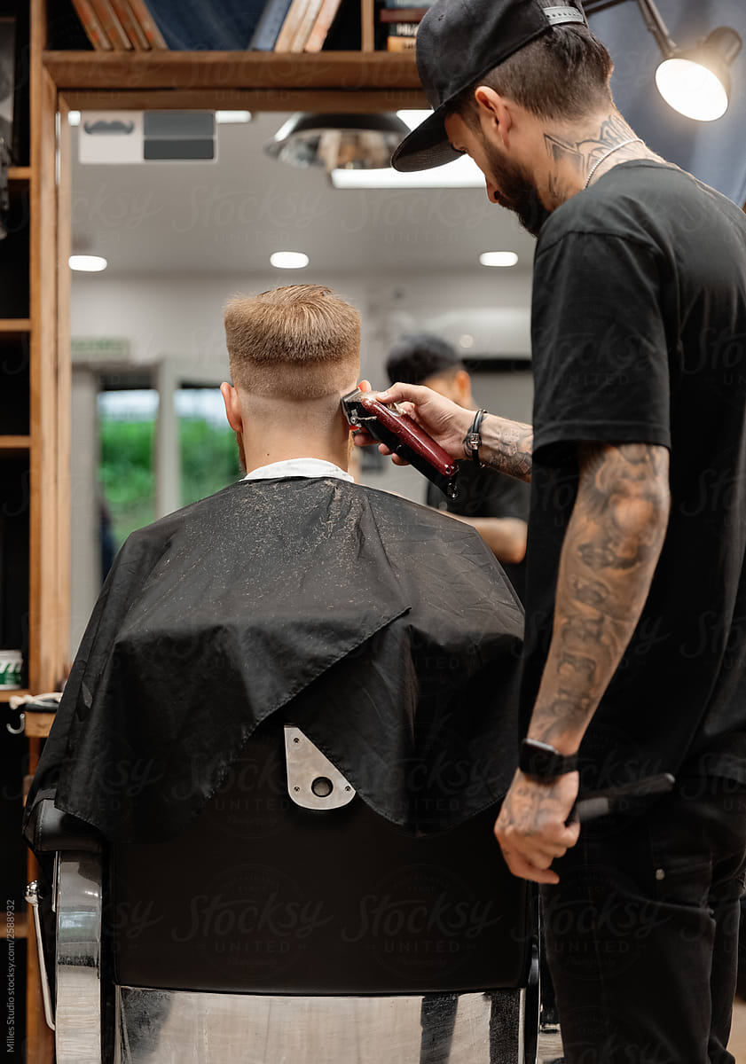 Man shaving client in barbershop