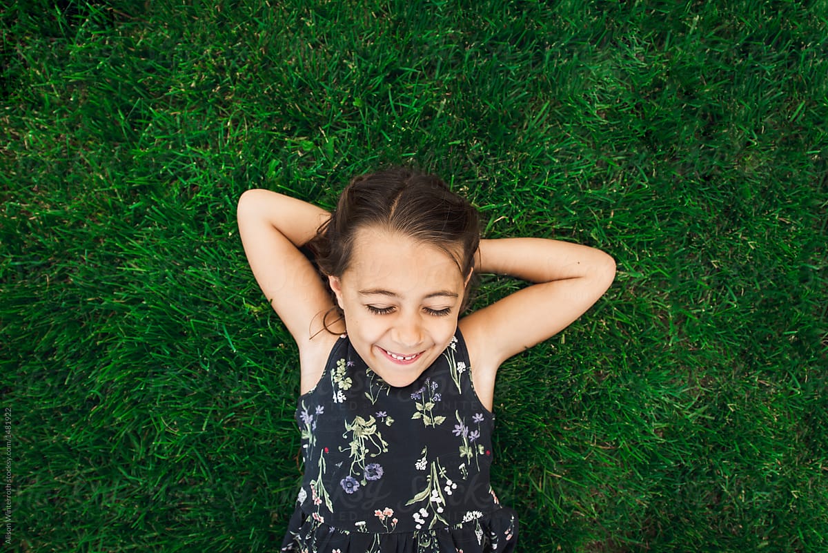 Child laying in grass