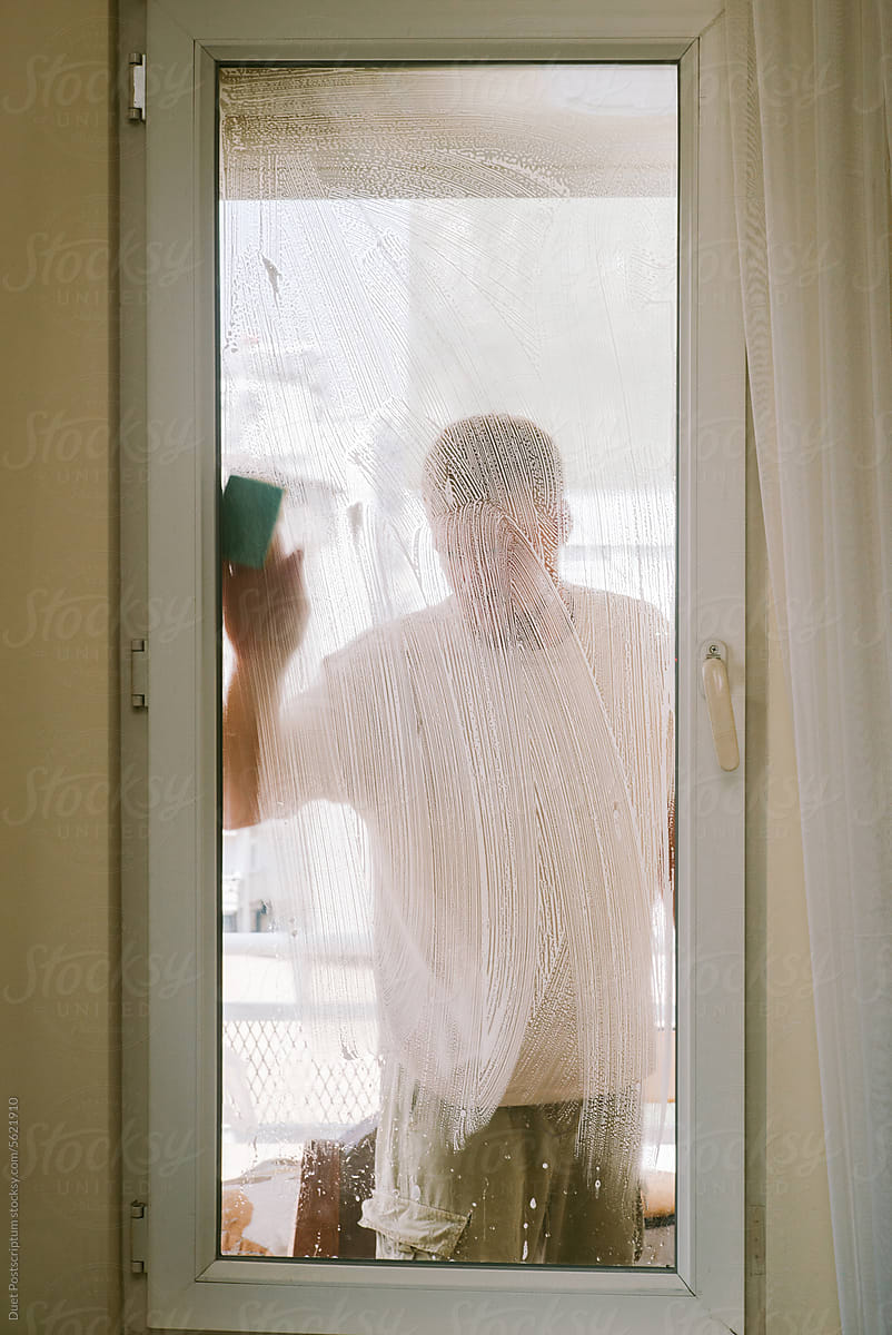 A man washes a window