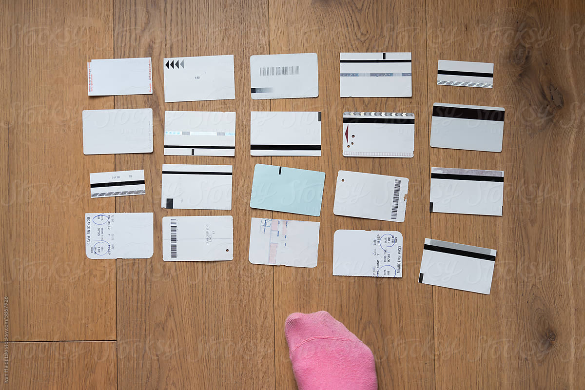 Top-down view pink socks feet with receipt, tickets on wood floor, UGC