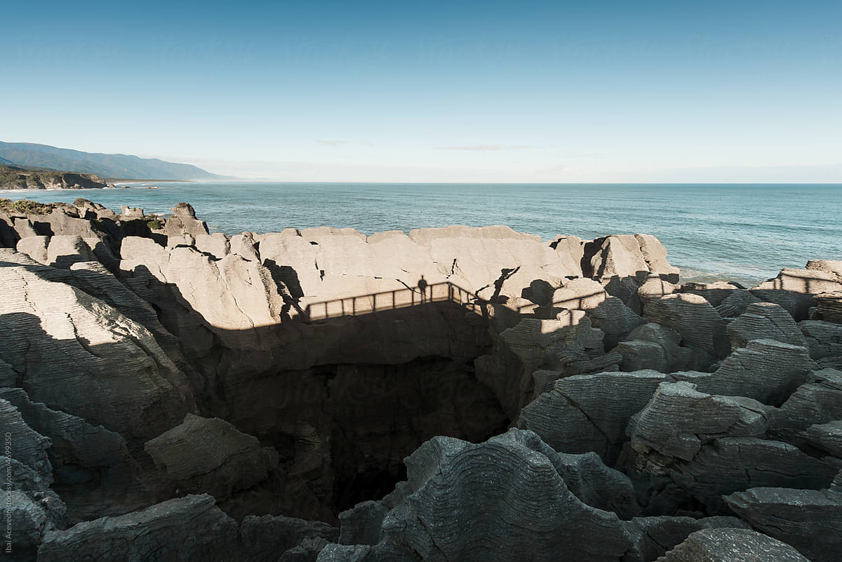 Human shadow on beautiful cliff rocks formation