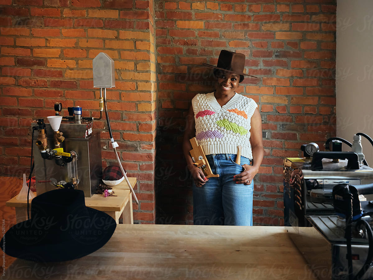 Black Woman Hat Maker In A Workshop Space Sews On A Sewing Machine by  Stocksy Contributor Iryna Shepetko - Stocksy