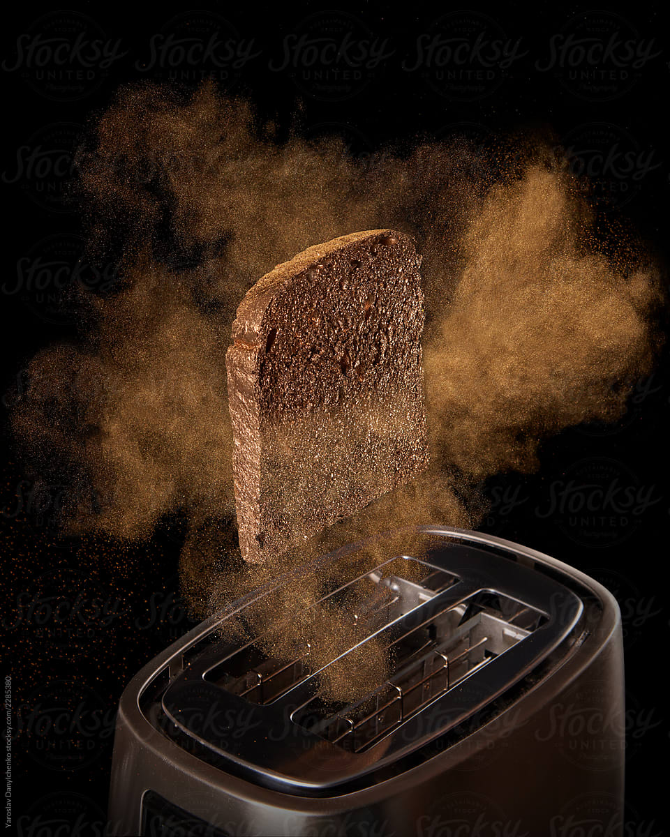 Jumping toast from the toaster on a black background. Preparing