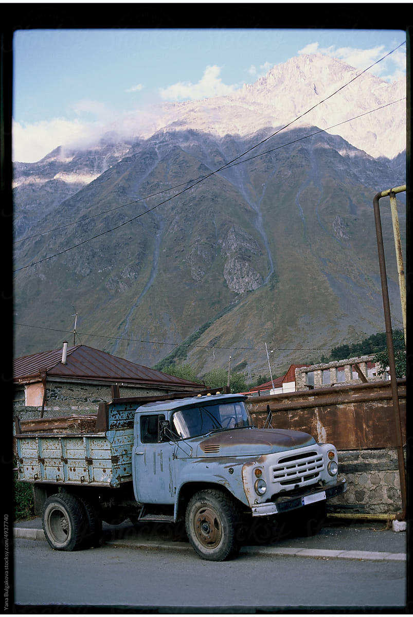 A truck in front of the mountains