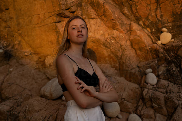 Beautiful Blonde Woman In Underwear By The Rocks by Stocksy