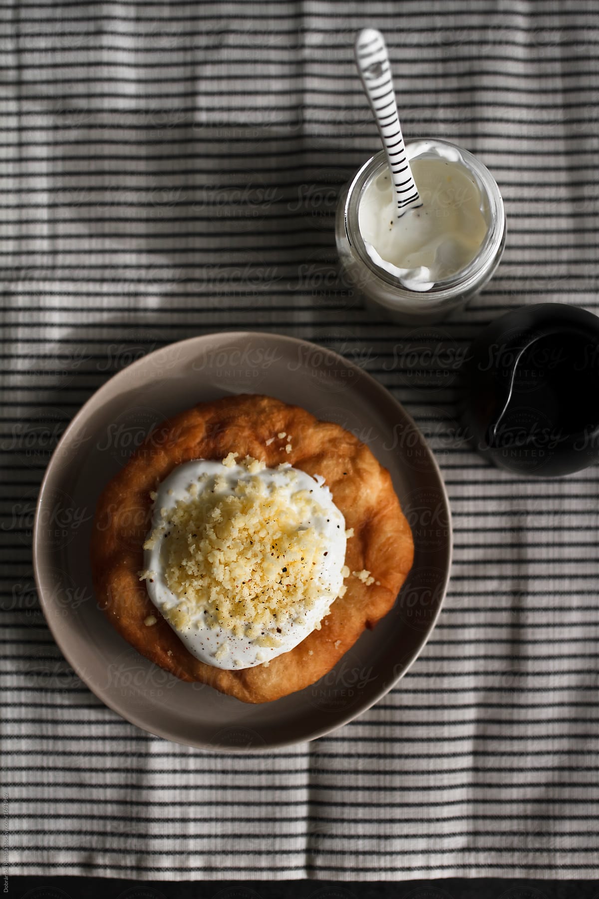 Langos (fried Hungarian flatbread with sour cream and grated cheese)