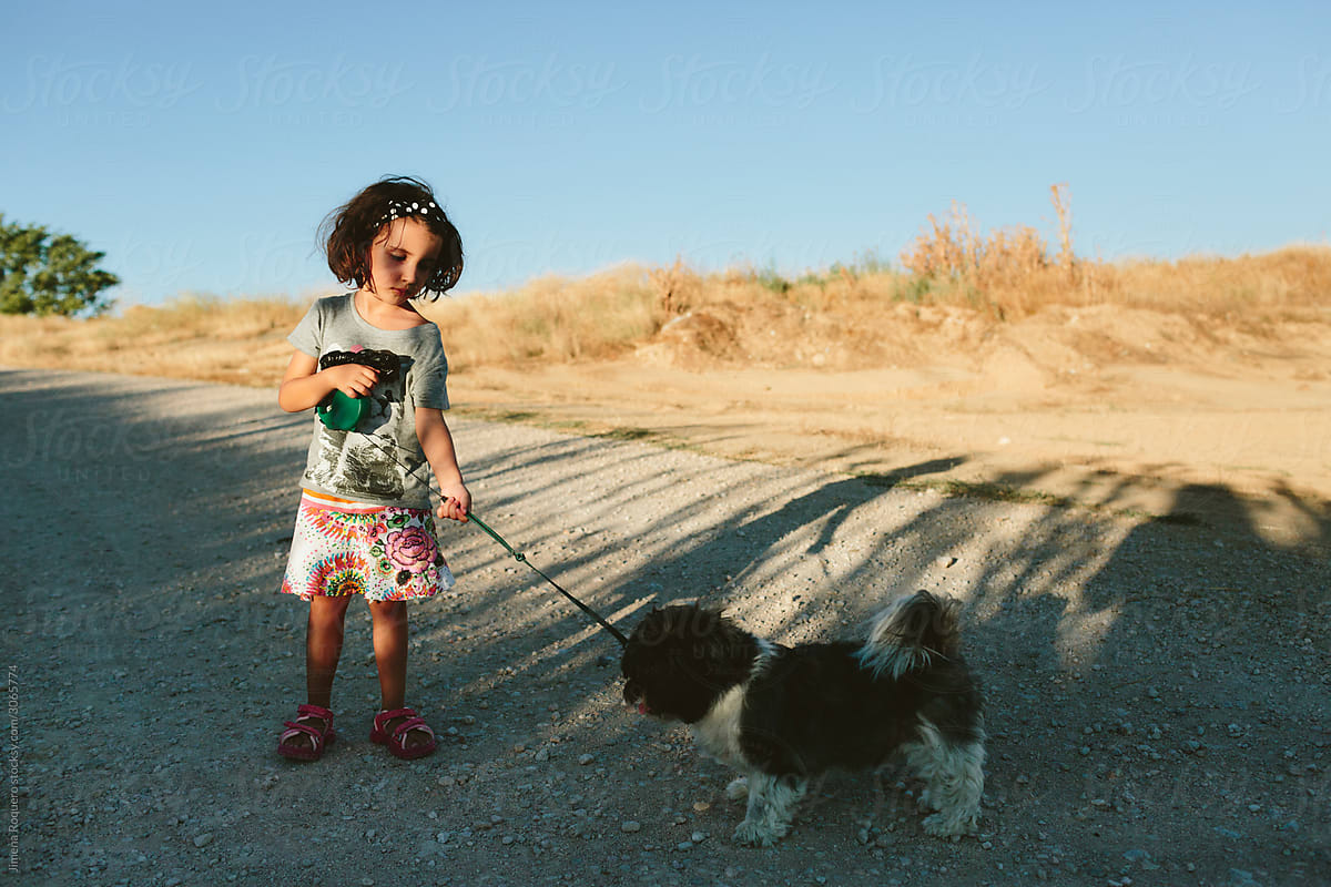 Kid with dog in rural path
