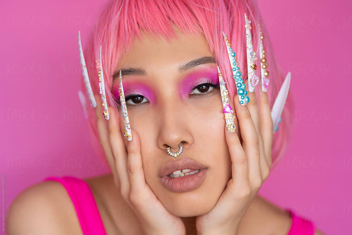 Asian woman with pink hair and trendy nails