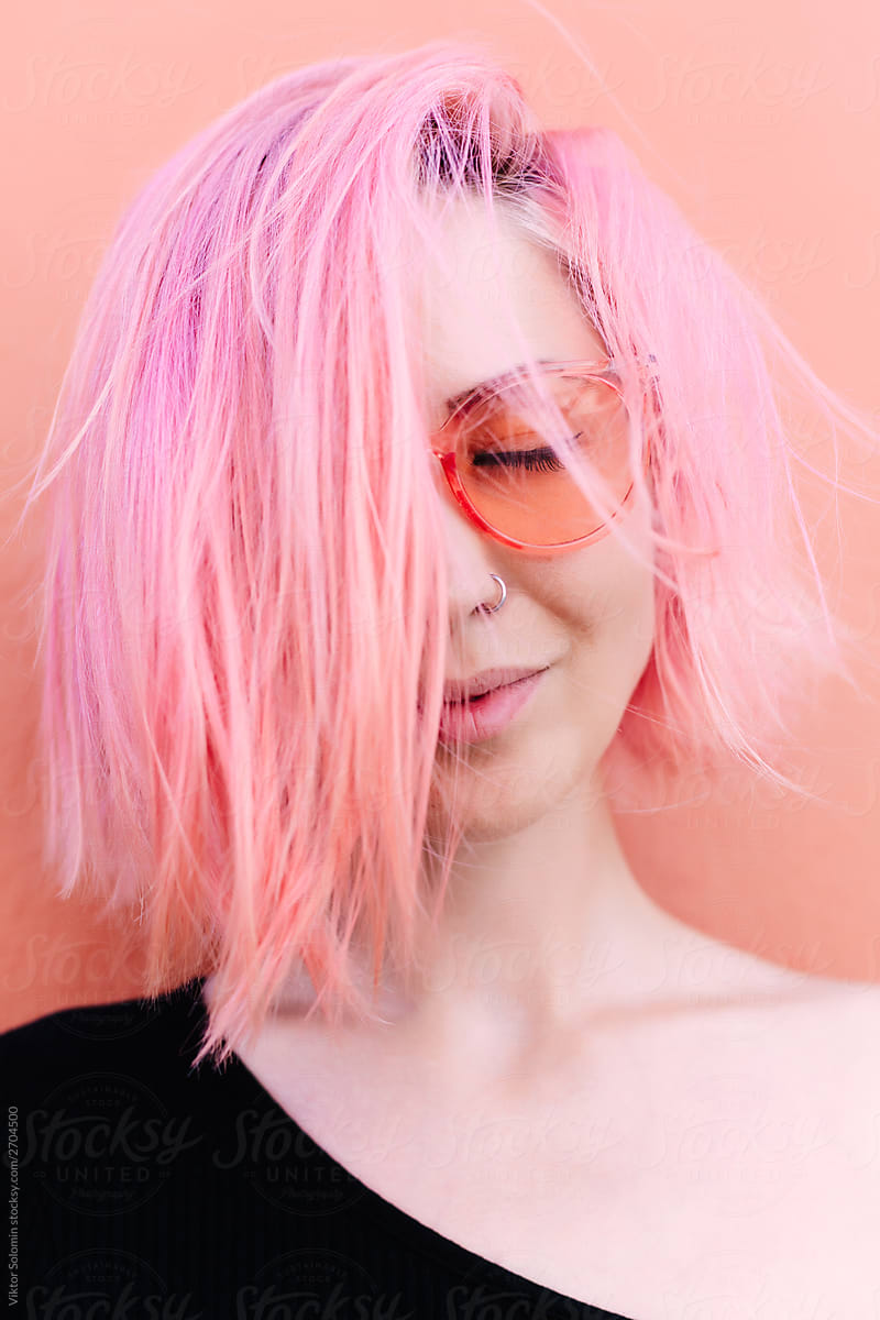 Summer colorful closeup portrait of young woman with pink hair. Vivid colors style.