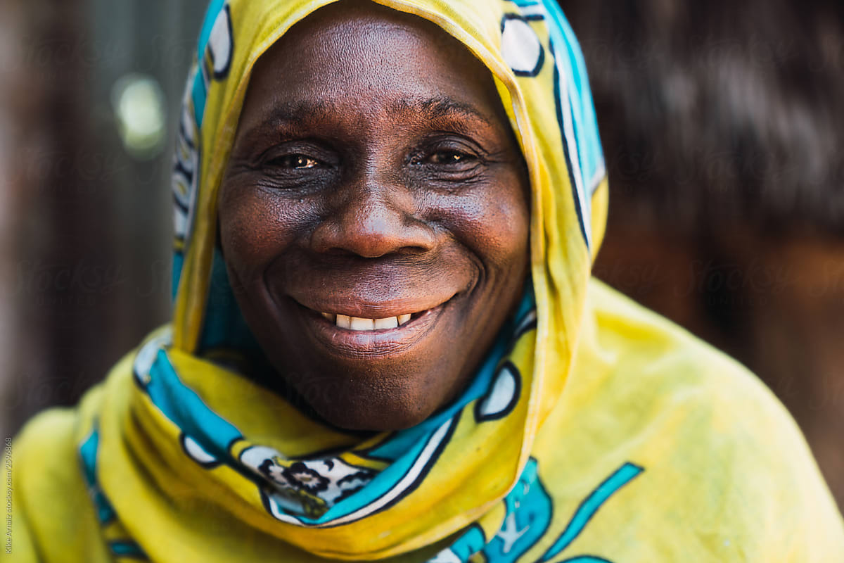 Zanzibari old woman smiling and wearing a yellow an turquoise hi