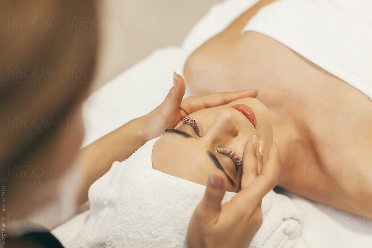 Woman Enjoying A Facial Massage By Stocksy Contributor Victor Torres Stocksy