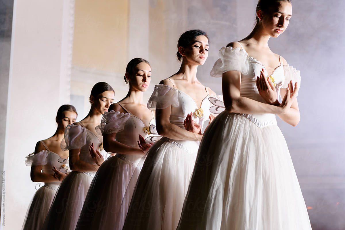 Ballerinas in dresses posing on scene