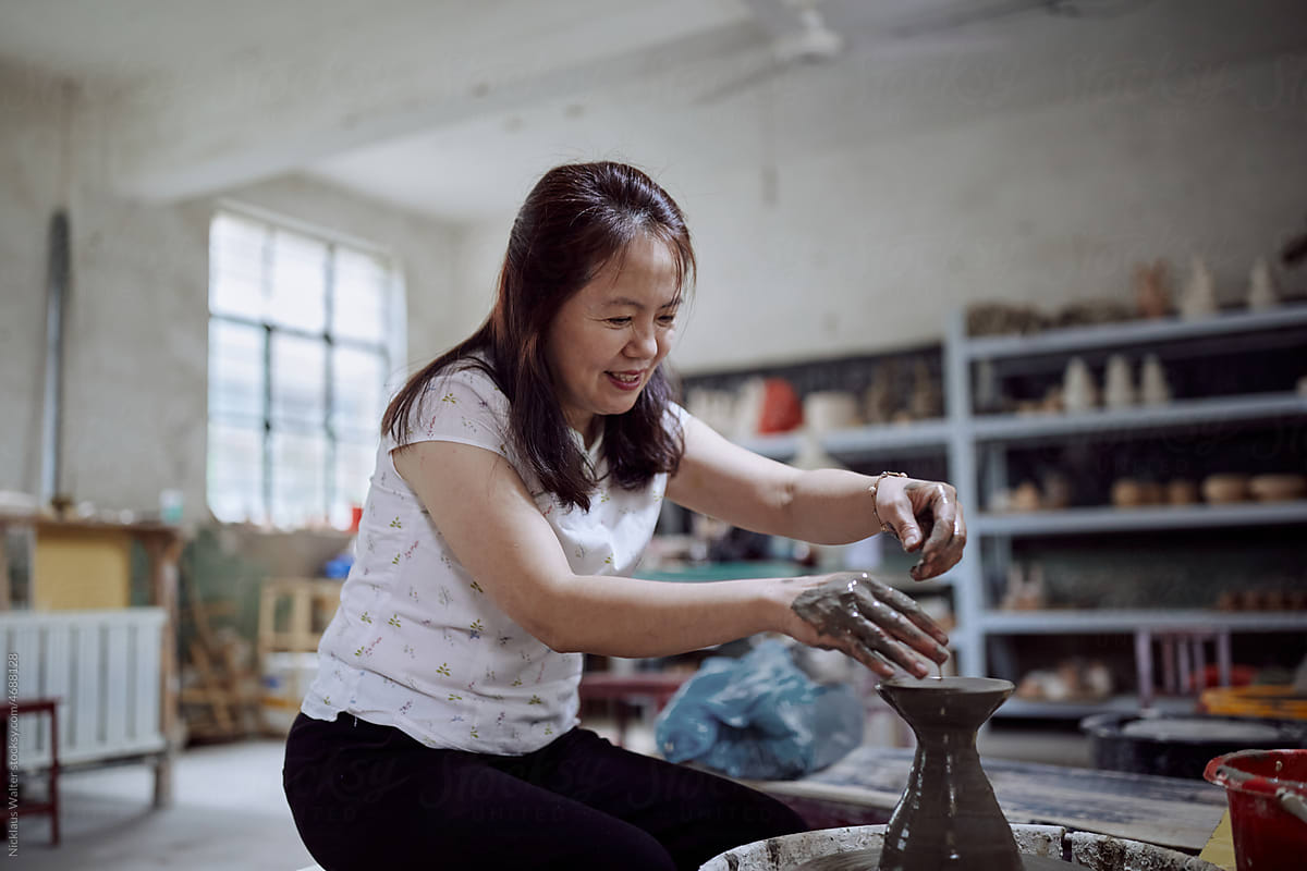 East Asian Small Business Owner Creates Pottery In Her Workshop