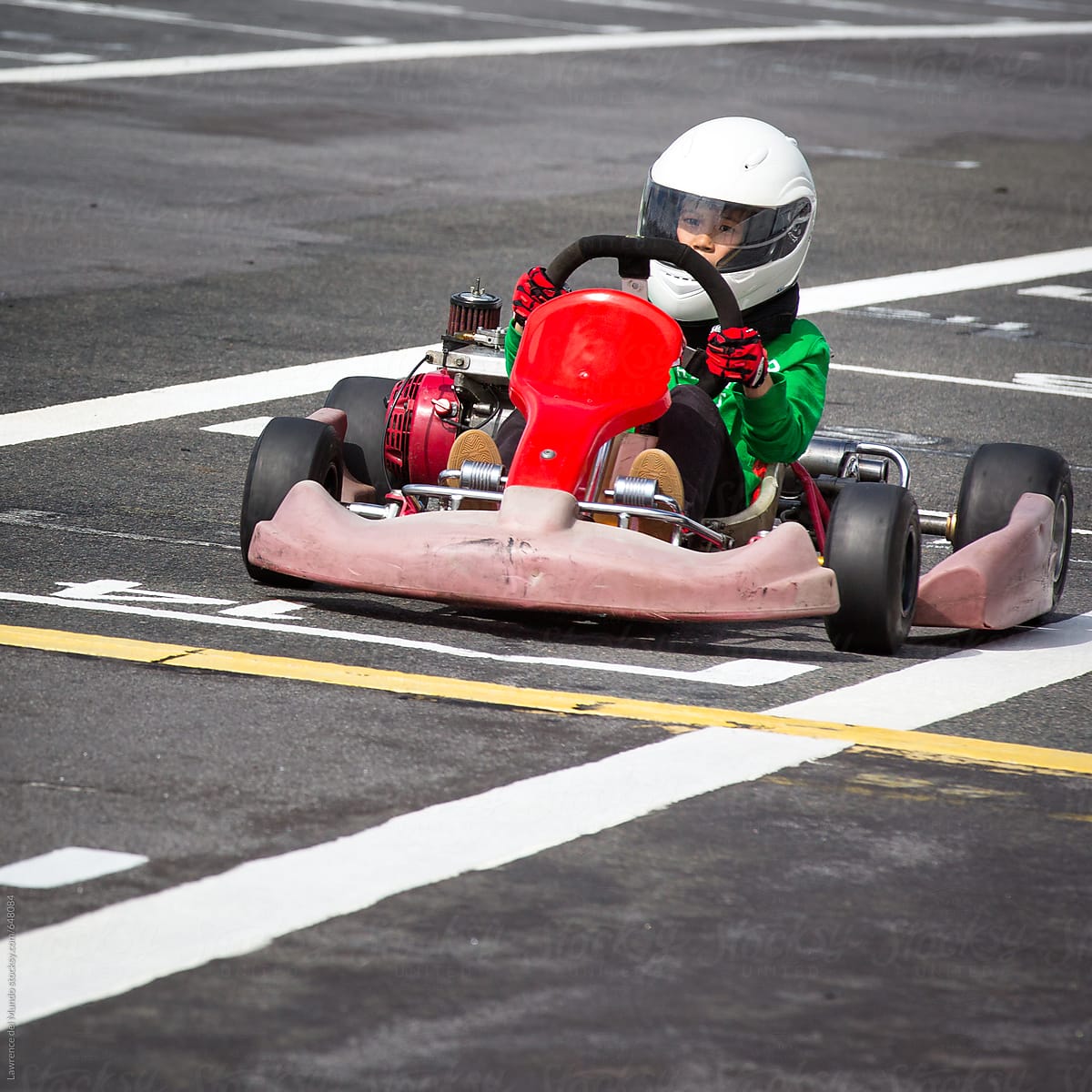 Young race kart driver about to cross the finish line