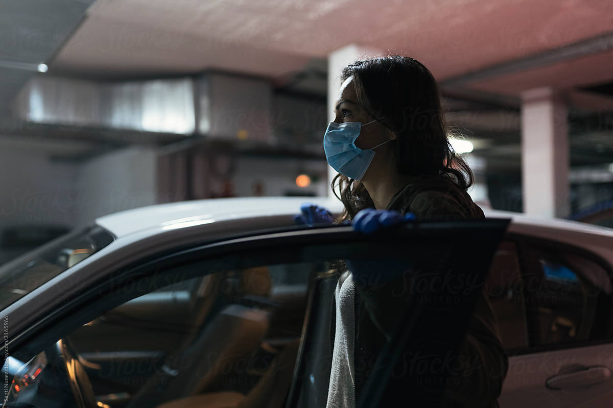 Woman wearing protective mask driving