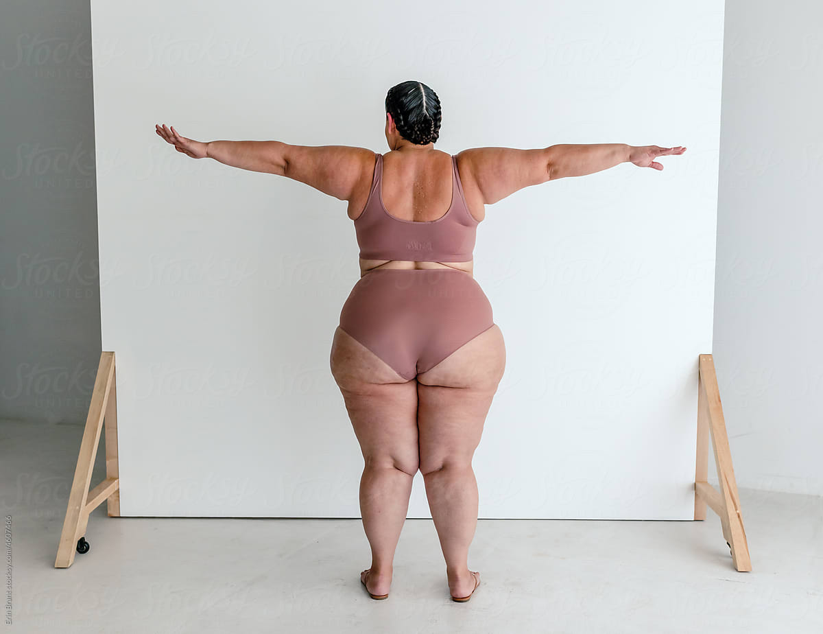 Rear view of plus-size woman in bra and underwear