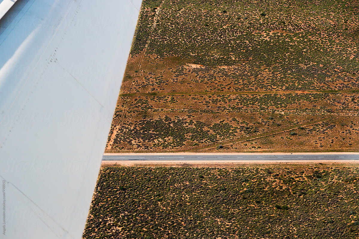 Aerial view of scrub and a desert road in Western Australia