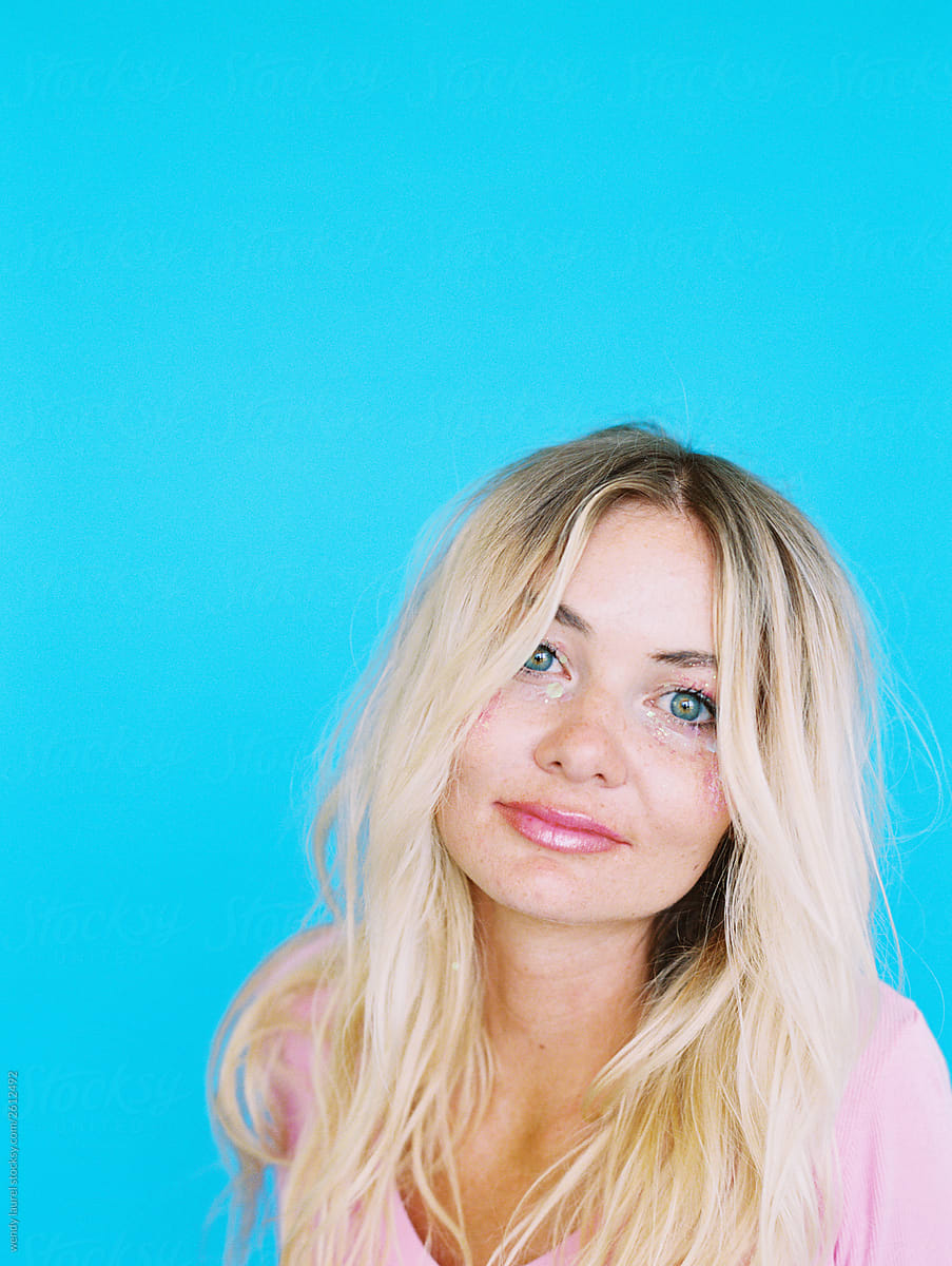 Pretty quirky blonde girl portraits against colored backgrounds being happy and joyful