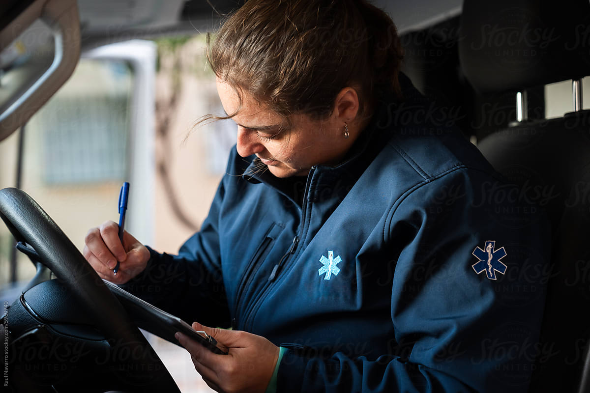 Female Paramedic Reviewing Medical Records