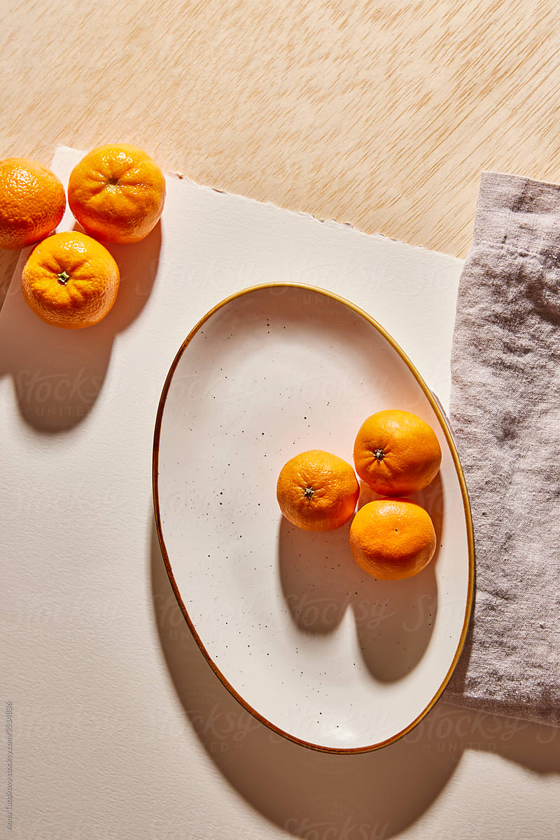 Multiple clementines on a plate