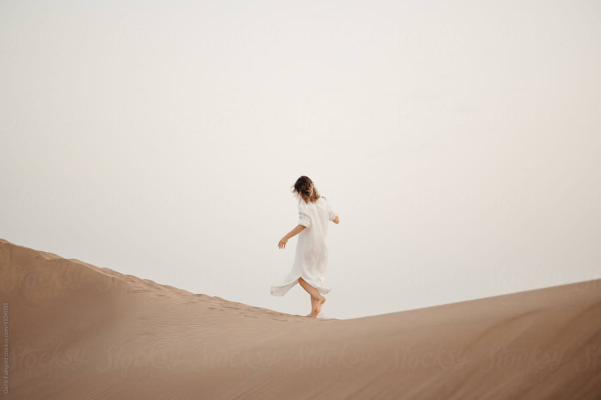 Walking woman on dune.