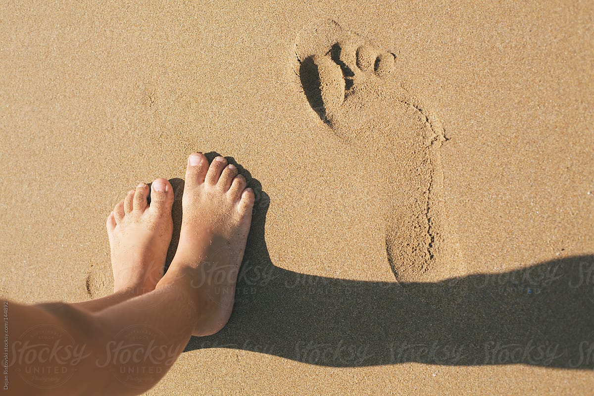 Child legs on the sand