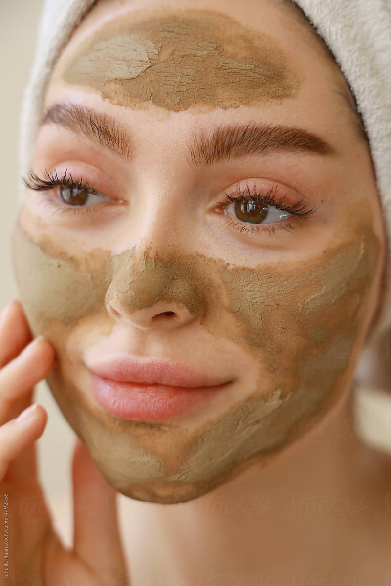 young woman applying facemask